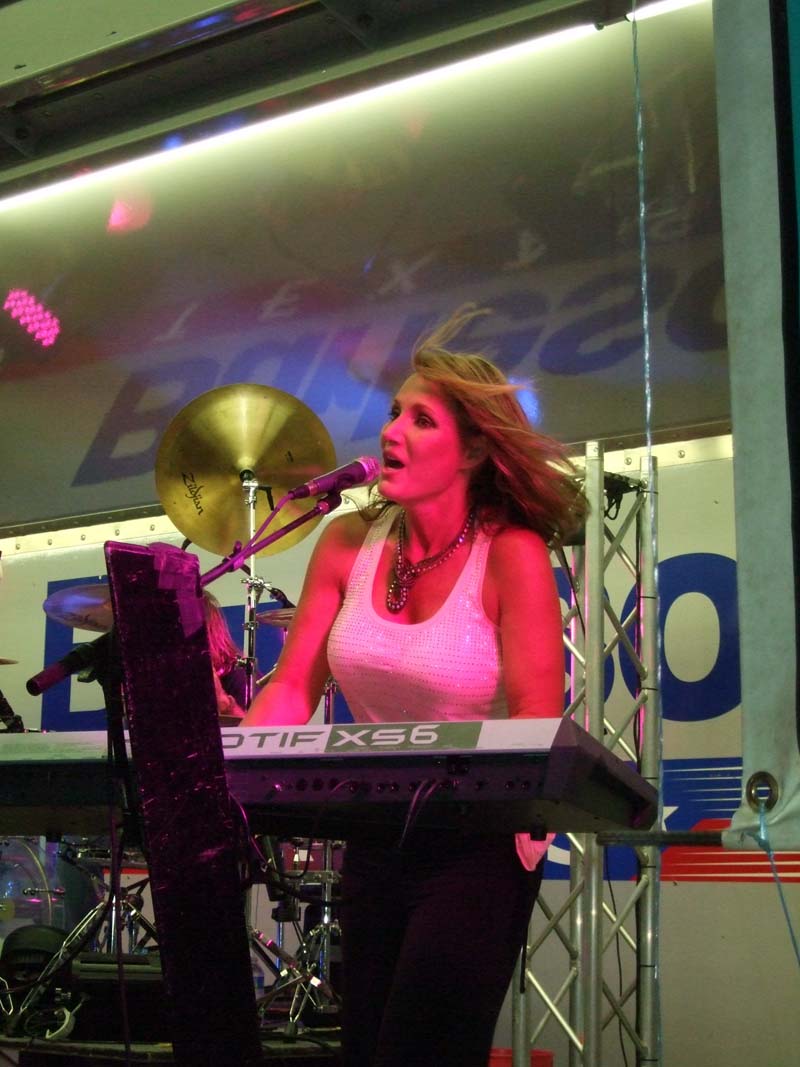 photo of woman singing and playing the piano